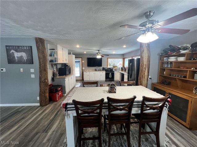 dining room featuring ceiling fan and dark wood-type flooring