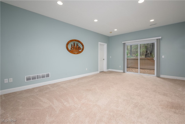 spare room featuring light colored carpet