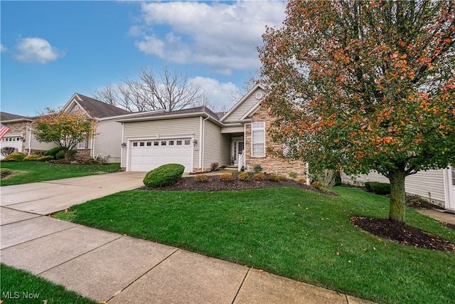 view of front of property featuring a garage and a front lawn