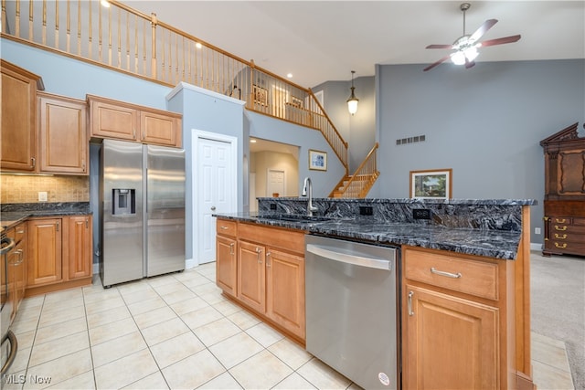 kitchen featuring ceiling fan, sink, stainless steel appliances, high vaulted ceiling, and light tile patterned floors