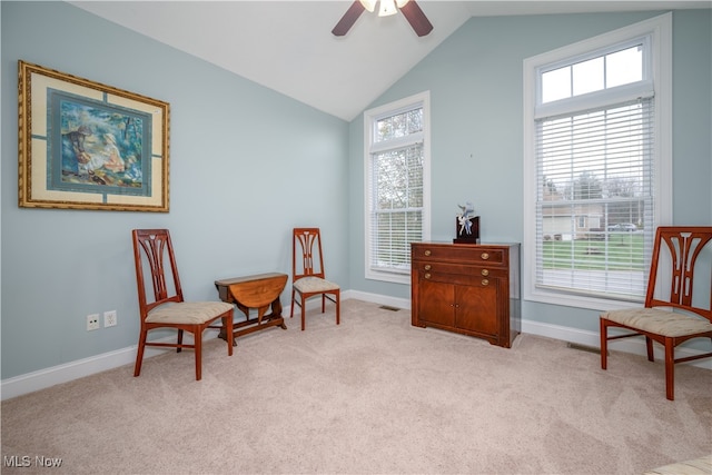 sitting room featuring light carpet, a healthy amount of sunlight, and vaulted ceiling