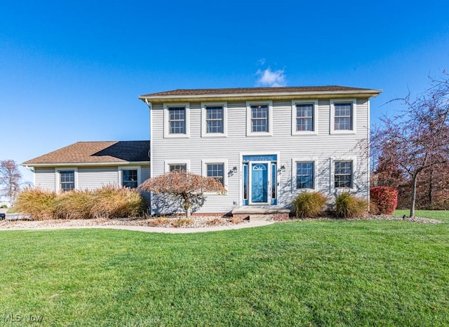 colonial-style house with a front lawn