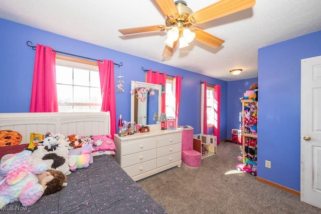 bedroom featuring ceiling fan and dark carpet