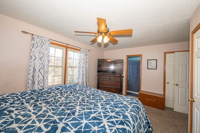 bedroom with a textured ceiling, carpet floors, and ceiling fan