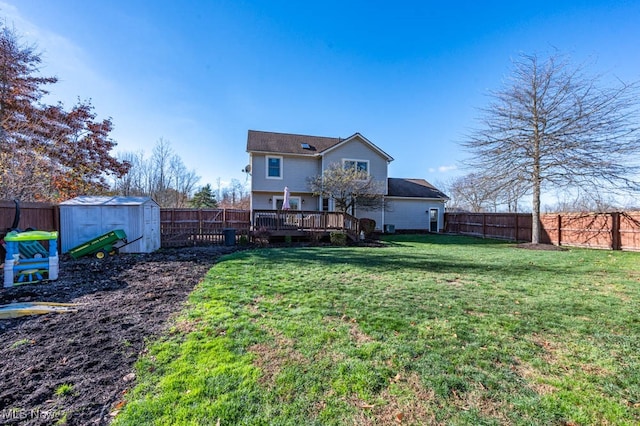 back of house with a wooden deck, a lawn, and a storage shed