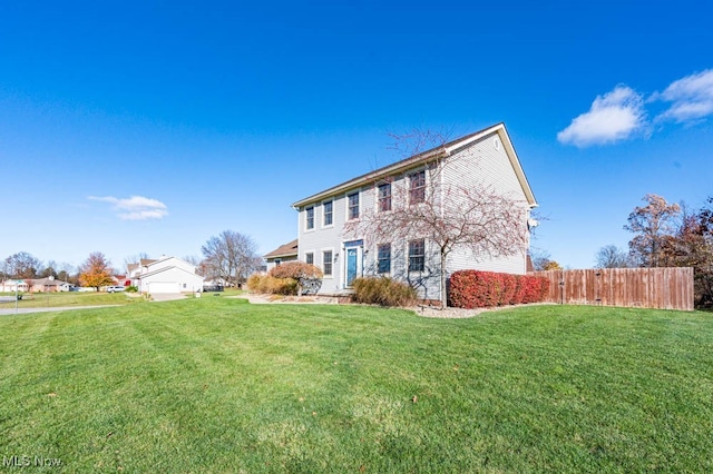 rear view of house featuring a lawn