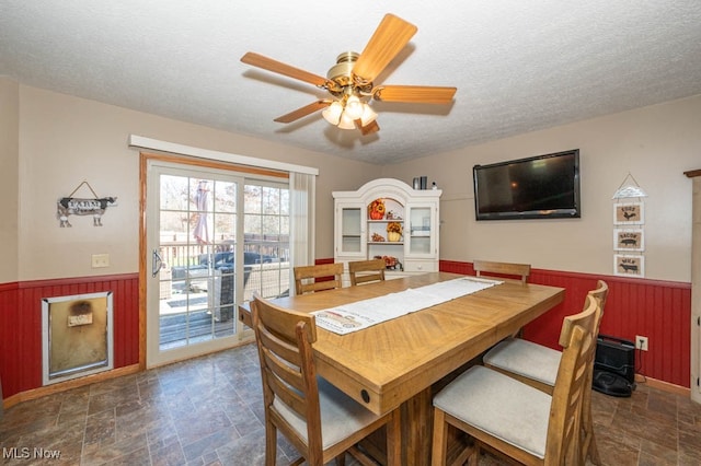 dining room featuring a textured ceiling and ceiling fan