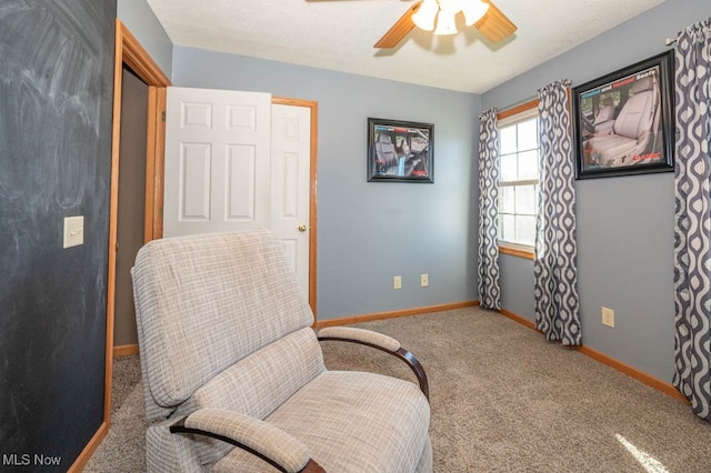 living area with ceiling fan and carpet floors