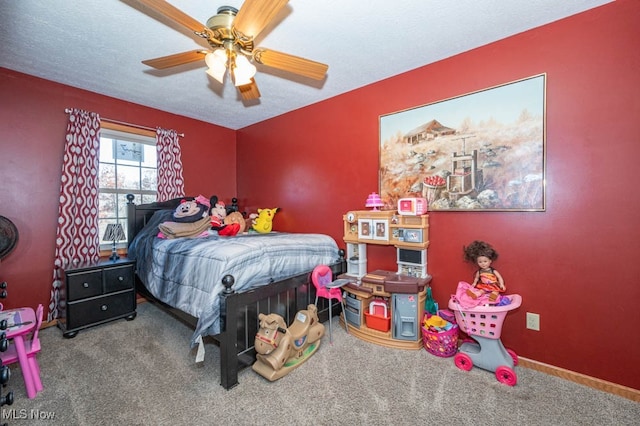 bedroom featuring ceiling fan, a textured ceiling, and carpet flooring