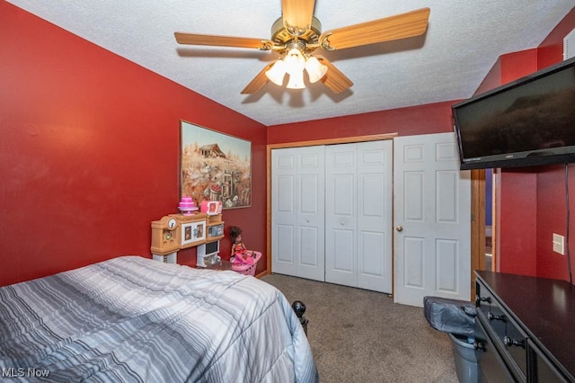 carpeted bedroom featuring ceiling fan, a textured ceiling, and a closet