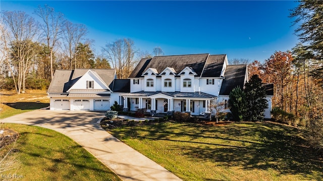 view of front of home with a front yard, a garage, and covered porch