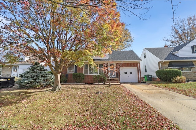 view of front of property featuring a garage and a front lawn