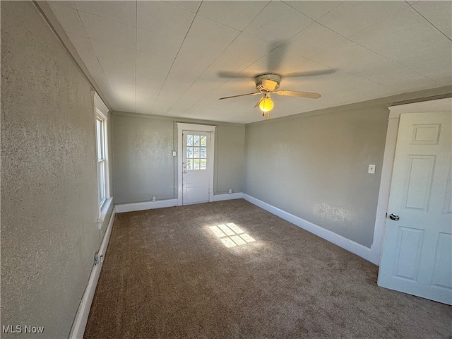 carpeted empty room featuring ceiling fan