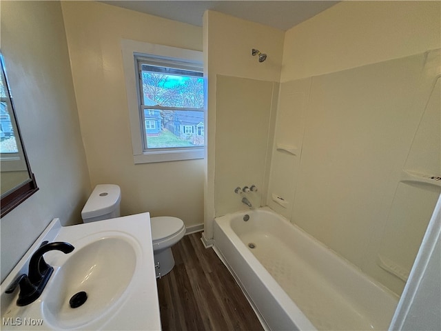 full bathroom with hardwood / wood-style floors, shower / tub combination, sink, and toilet