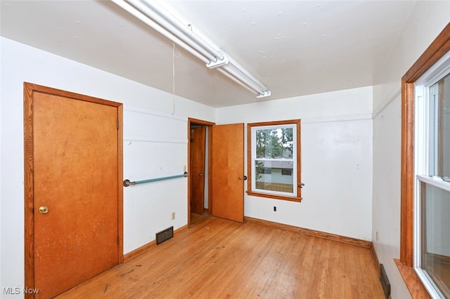 empty room with light hardwood / wood-style flooring