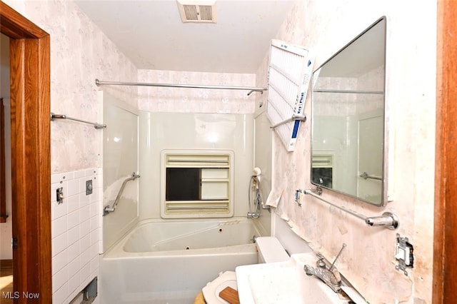 bathroom with tub / shower combination and sink