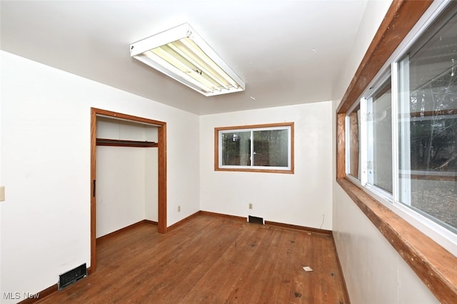 unfurnished bedroom featuring a closet and wood-type flooring