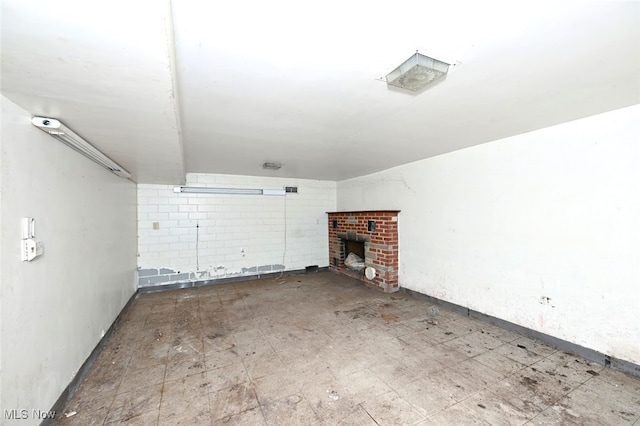 unfurnished living room with a brick fireplace