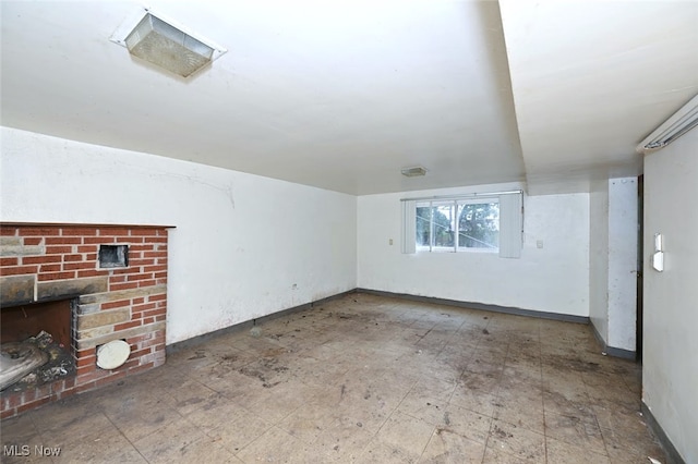 unfurnished living room featuring a brick fireplace