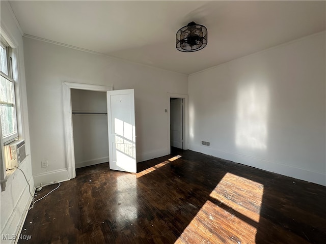 unfurnished bedroom featuring dark hardwood / wood-style floors and ornamental molding