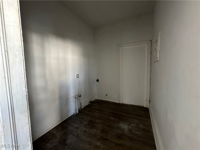 clothes washing area with dark hardwood / wood-style floors