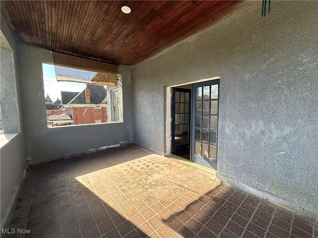 unfurnished sunroom with wood ceiling