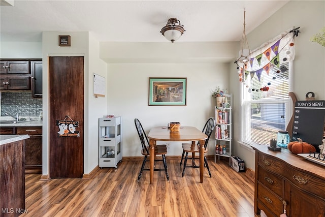 dining room with dark wood-type flooring and sink