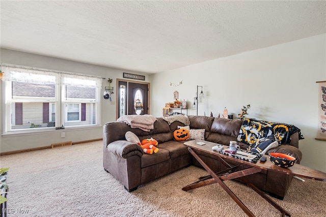 carpeted living room featuring a textured ceiling