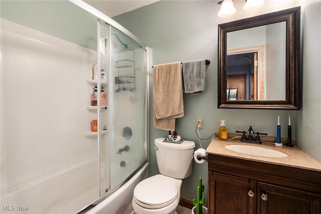 full bathroom featuring toilet, vanity, and enclosed tub / shower combo