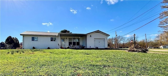 view of front of home with a porch, a front lawn, and a garage