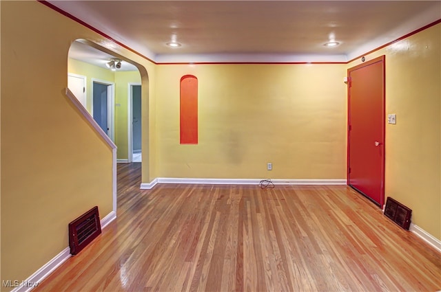 empty room with light hardwood / wood-style flooring