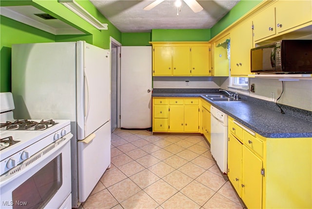 kitchen featuring light tile patterned flooring, a textured ceiling, sink, white appliances, and ceiling fan