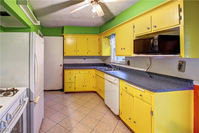 kitchen featuring white appliances, sink, ceiling fan, and a textured ceiling