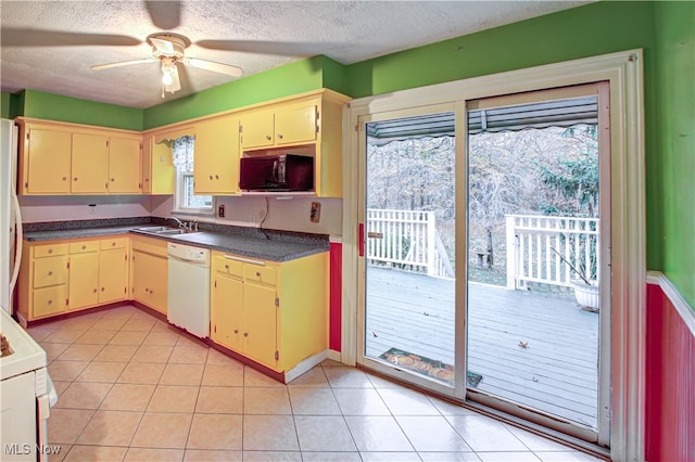 kitchen featuring white appliances, ceiling fan, a textured ceiling, and sink