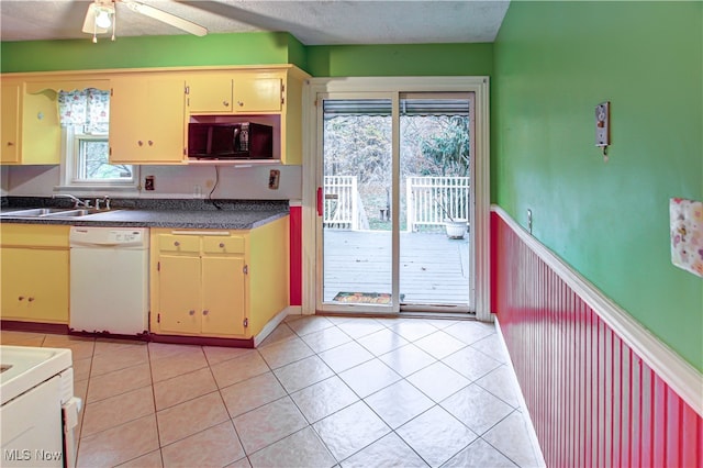 kitchen with light tile patterned floors, ceiling fan, sink, and dishwasher