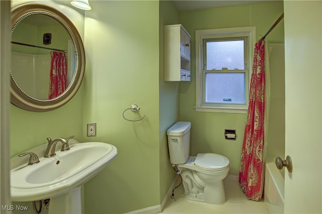 full bathroom featuring shower / bath combo, tile patterned floors, sink, and toilet