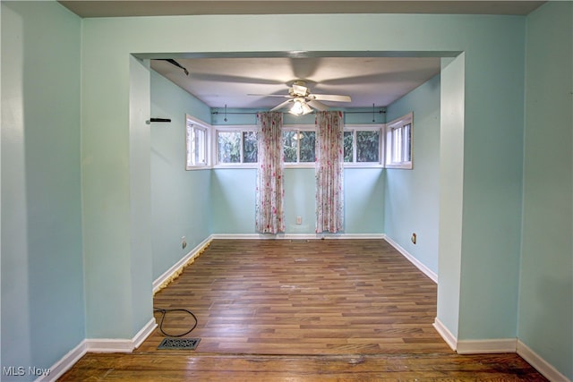 spare room with hardwood / wood-style flooring and ceiling fan