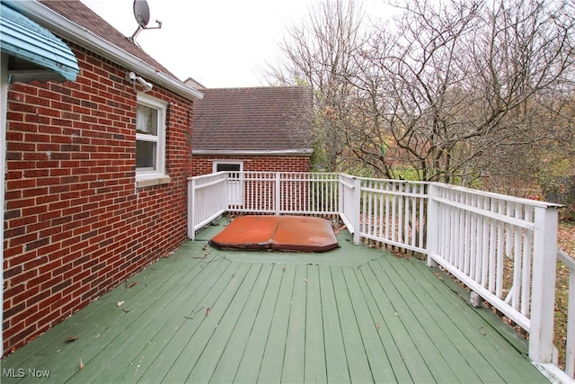 deck with a covered hot tub