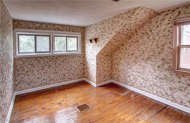 additional living space with light wood-type flooring and plenty of natural light