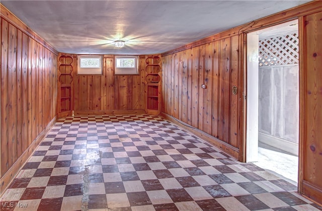 empty room featuring wood walls