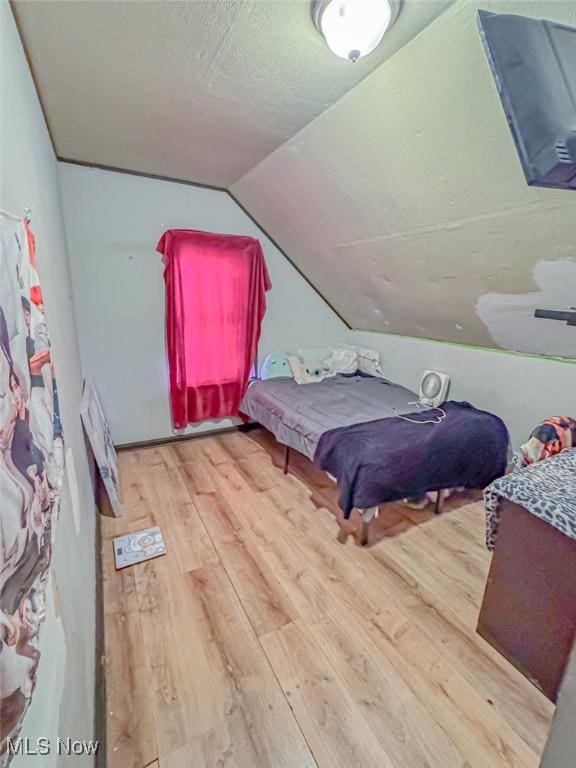 1330 W 18th St, Lorain, OH 44052 - bedroom featuring lofted ceiling, wood finished floors, and a textured ceiling