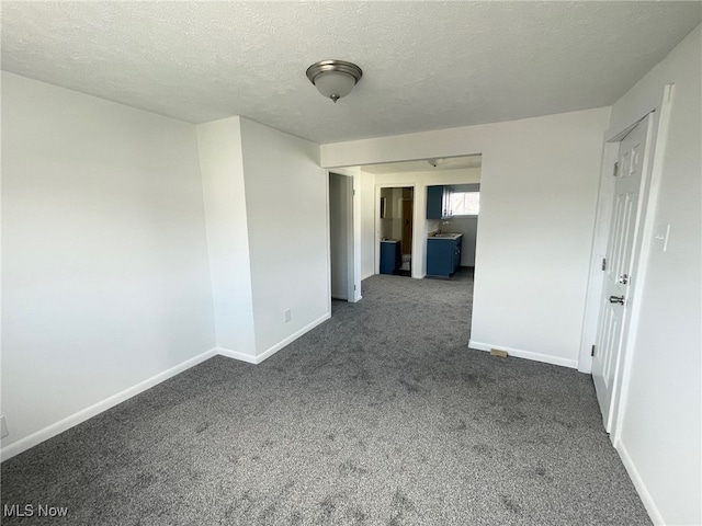 carpeted spare room with a textured ceiling