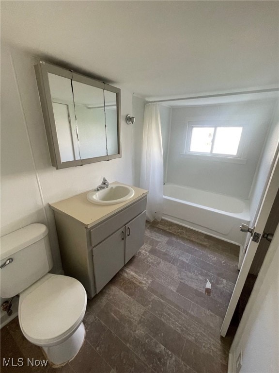 full bathroom with hardwood / wood-style floors, vanity, toilet, and shower / tub combo with curtain