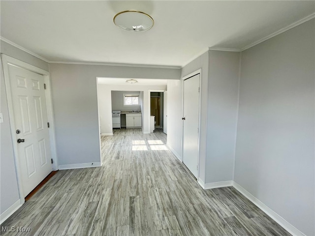 hallway featuring light hardwood / wood-style floors and crown molding