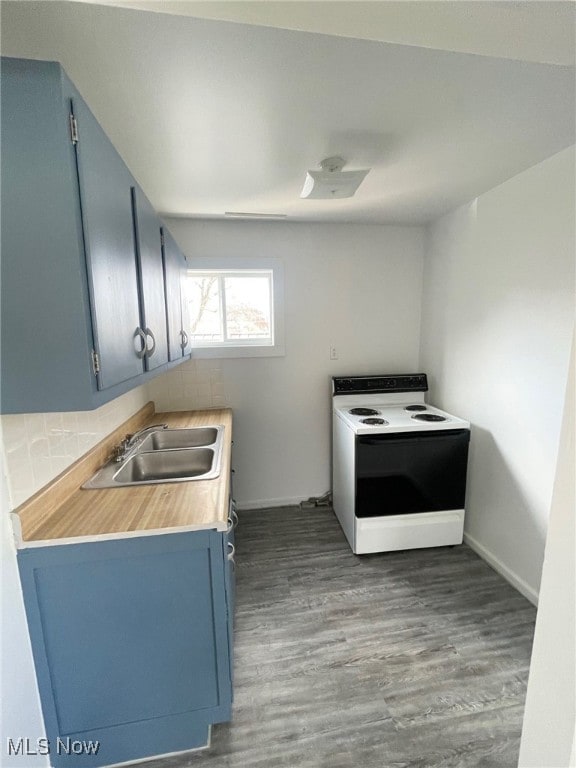 kitchen with blue cabinetry, wood-type flooring, sink, and electric range