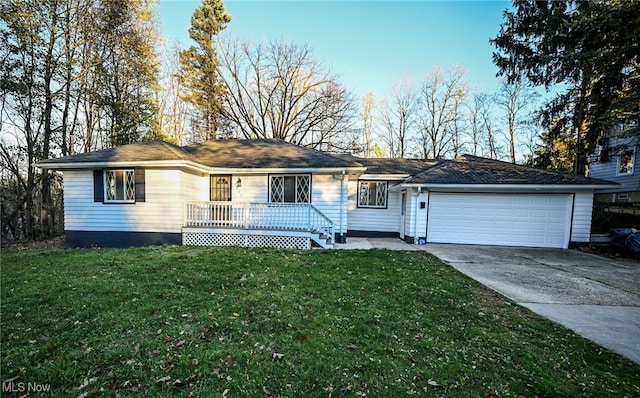 ranch-style house with a garage and a front lawn