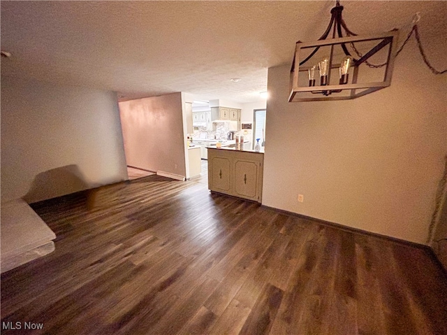 unfurnished dining area with dark hardwood / wood-style floors and a textured ceiling