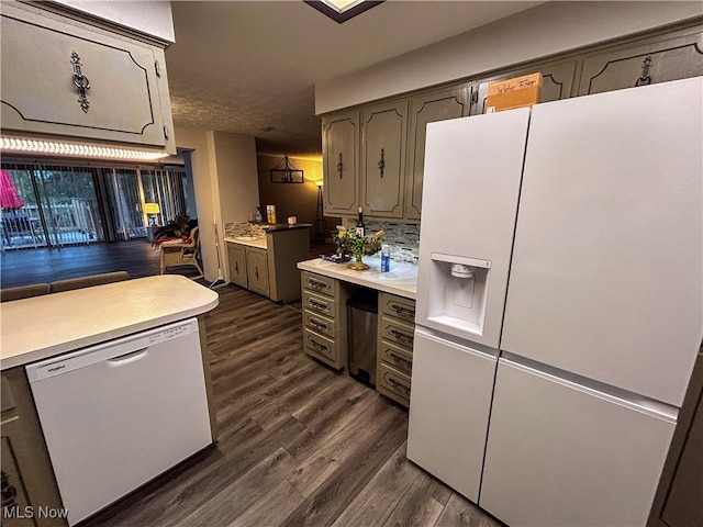 kitchen featuring white appliances, backsplash, dark hardwood / wood-style floors, and a textured ceiling