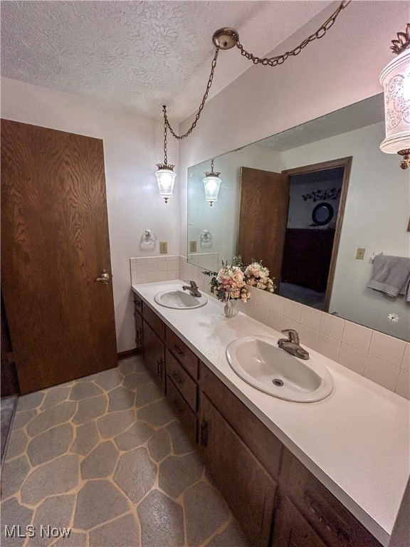 bathroom with vanity and a textured ceiling