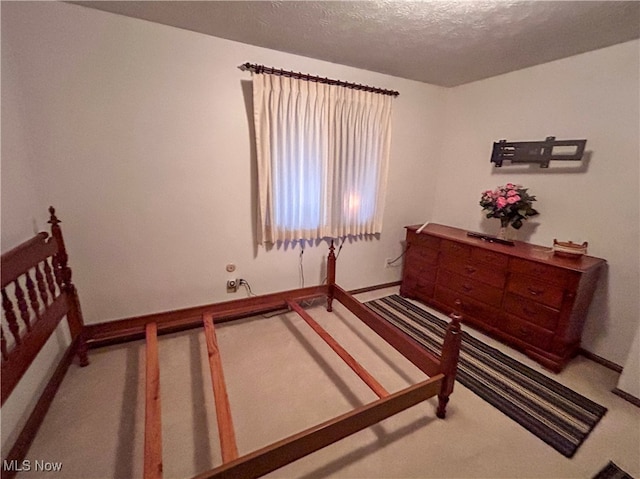 carpeted bedroom featuring a textured ceiling